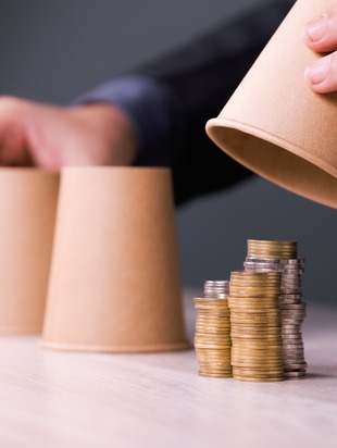 coins hidden under a cup showing hidden benefits